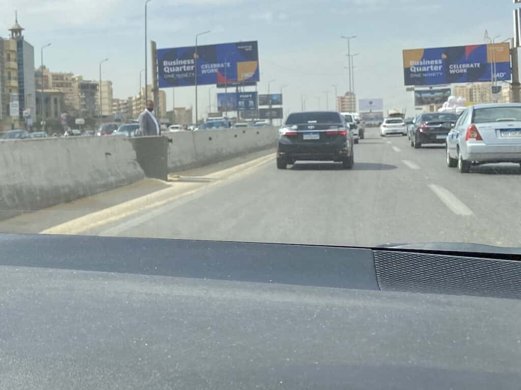 Man standing in the middle of the freeway in Cairo