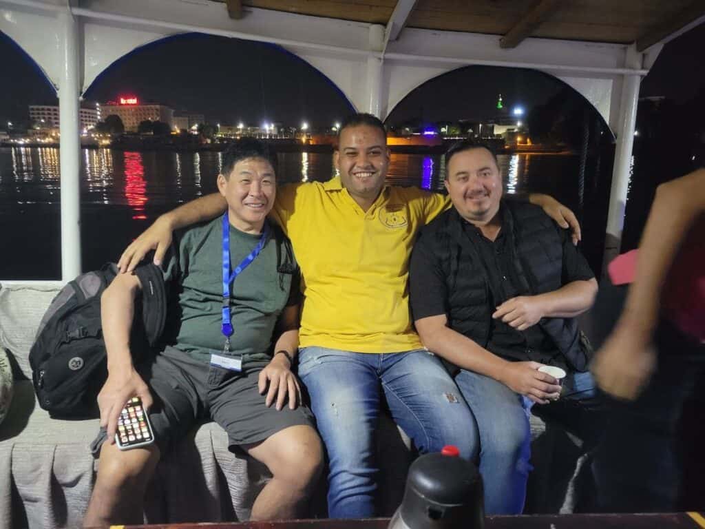 Three guys sitting on a boat