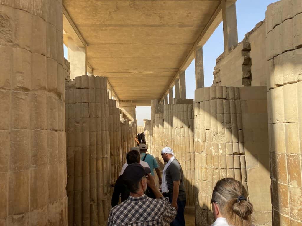 Walking through a hallway of stone columns