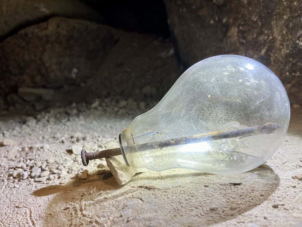 Lightbulb with a rusty nail inside