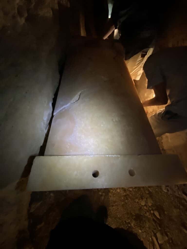 A stone sarcophagus with a lid deep inside the Step Pyramid
