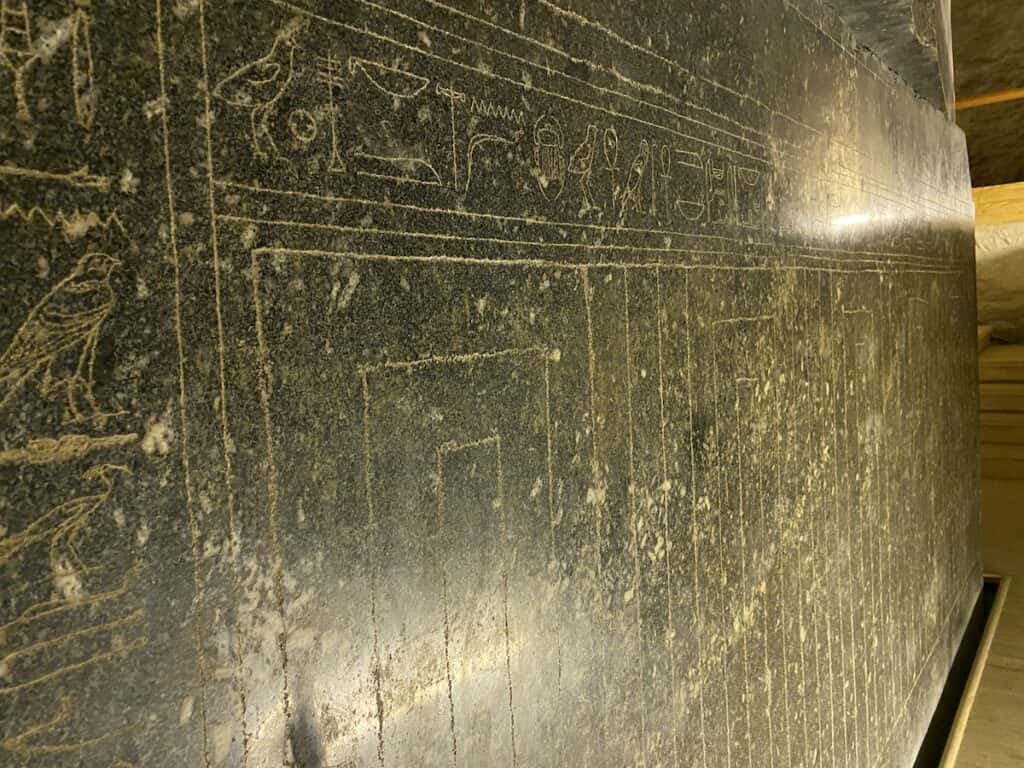 Close up view of scratched art work on a box in the Serapeum.