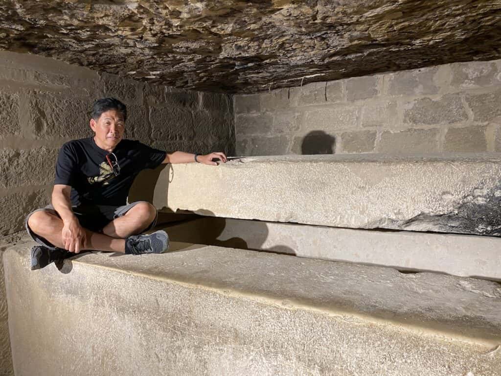 Man next to Ty's open sarcophagus