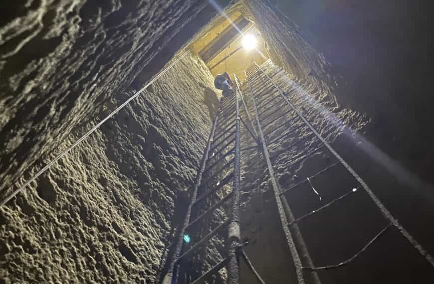 Climbing down ladder to second level of the Osiris Shaft