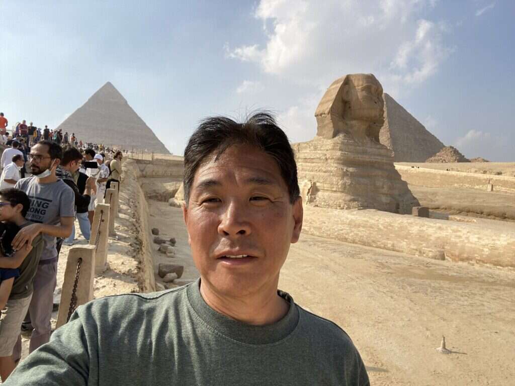 Man in front of the Sphinx, right side.