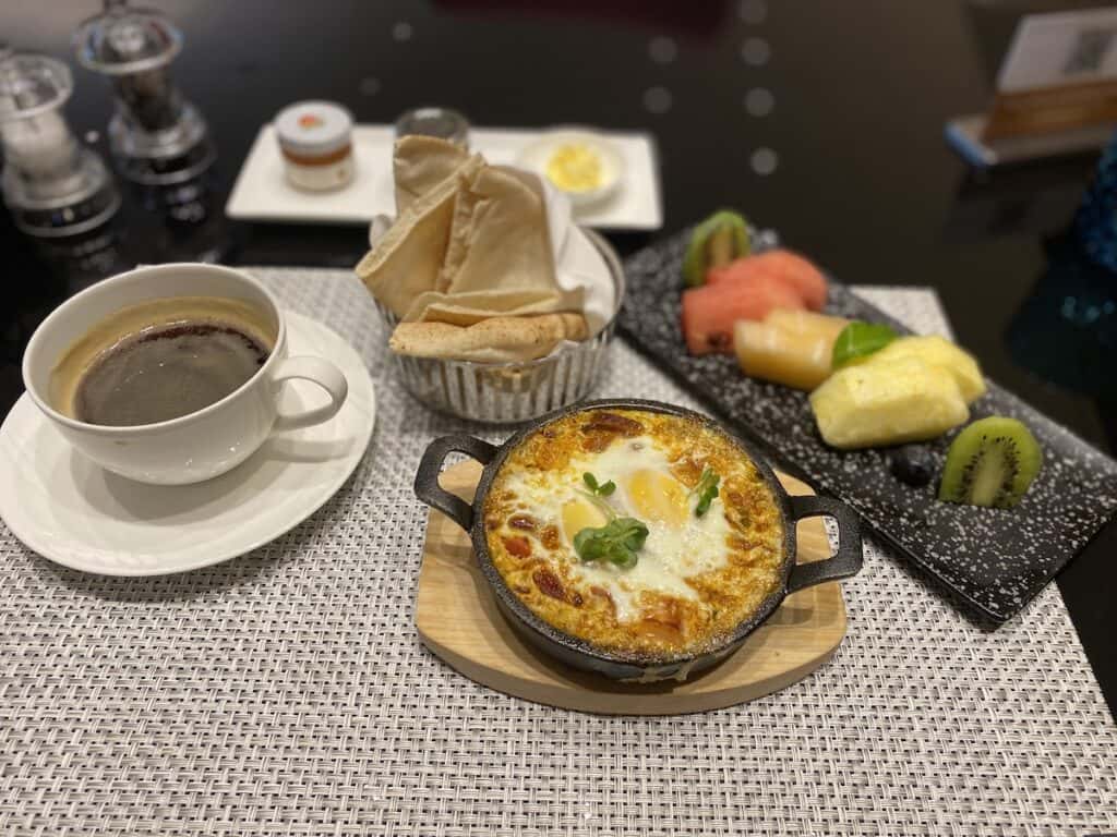 Shakshuka breakfast, fresh fruit and coffee at Al Safwa