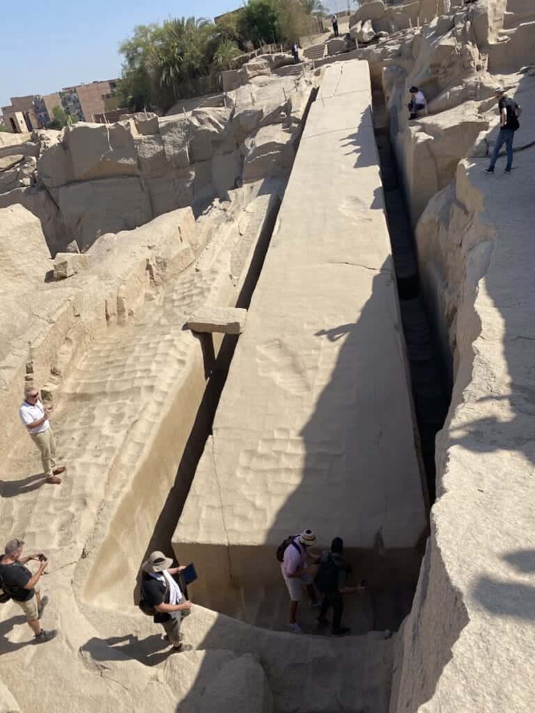 People looking at the Unfinished Obelisk scoop marks at Aswan Quarry