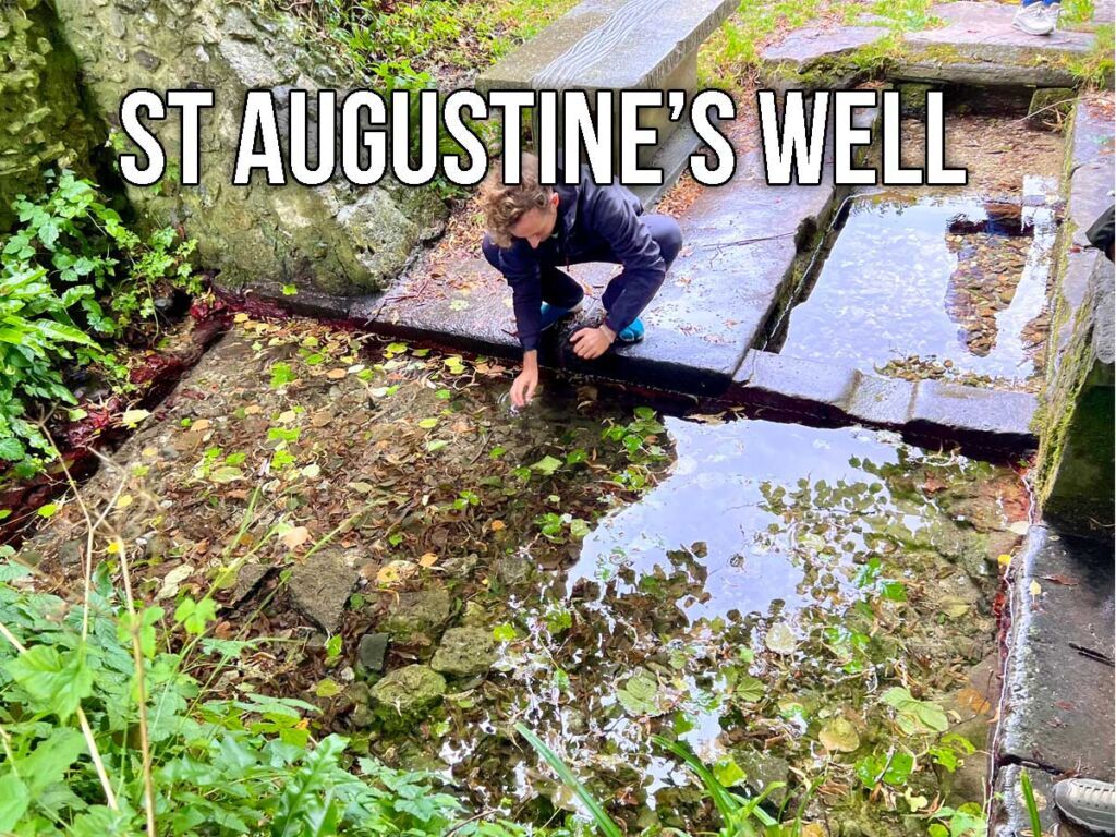 Man touching the water at St. Augustine's Well in Dorset, England