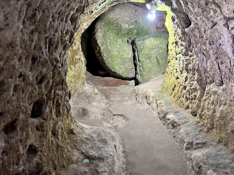 Up one of the passages, a stone door blocks the way.