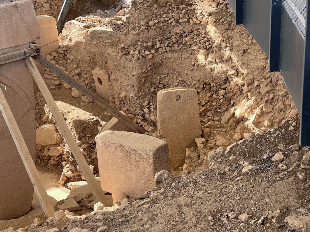 Gobekli Tepe Holed Sighting Stone, then Pillar 30 with a hole, and Pillar 22 in front.