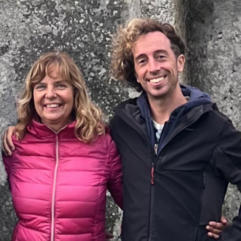 Arianna Mendo and Enrico Gelain of Ancient Spirit Tours in front of a standing stone