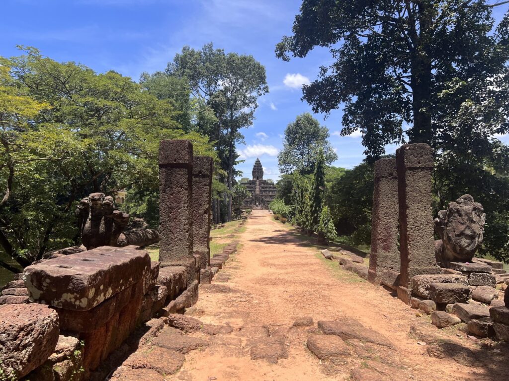 The laterite causeway into Bakong temple, framed by stone pillars and naga heads
