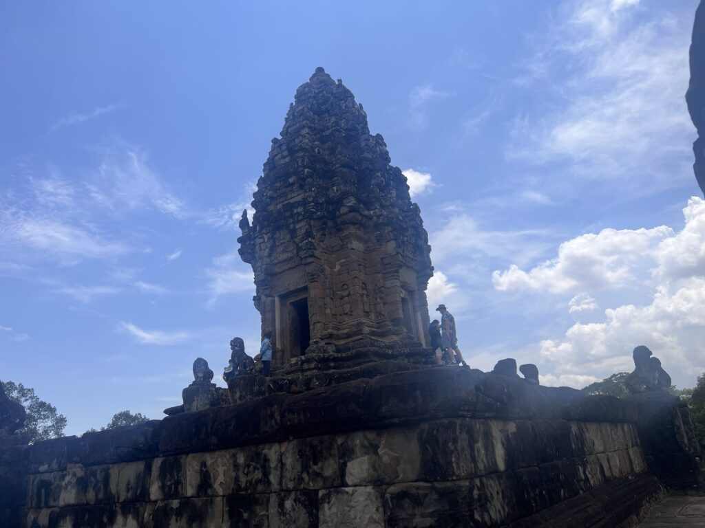 The sandstone central tower of Bakong temple rising above the top level of the pyramid