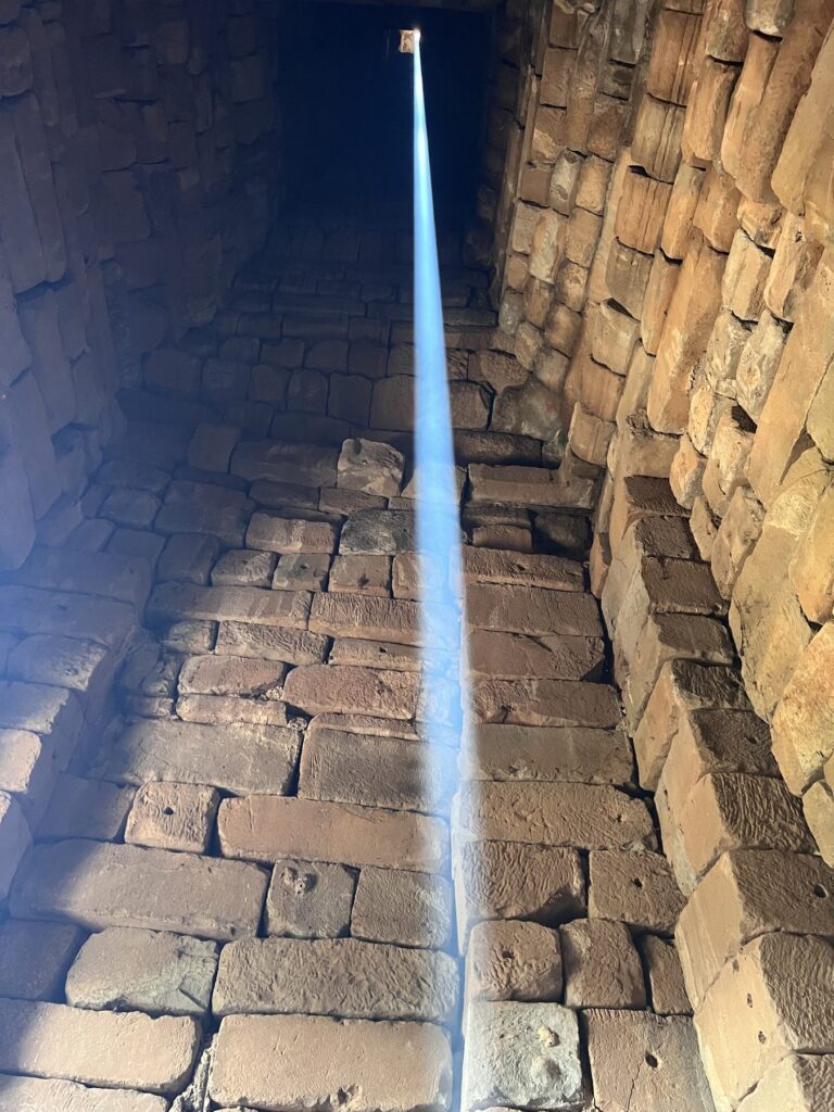 A thin beam of sunlight running the full height of Bakong's corbelled central tower