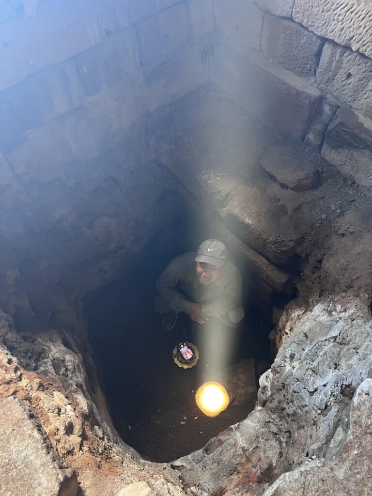 The zenith sunbeam dropping into the pit in the floor of Bakong's central sanctuary with Kanha below