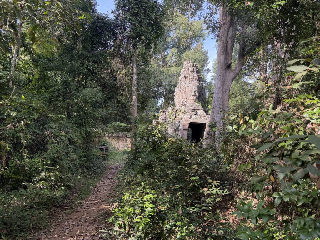 A dirt bike trail through the jungle leading to the face-tower south gate of Banteay Kdei