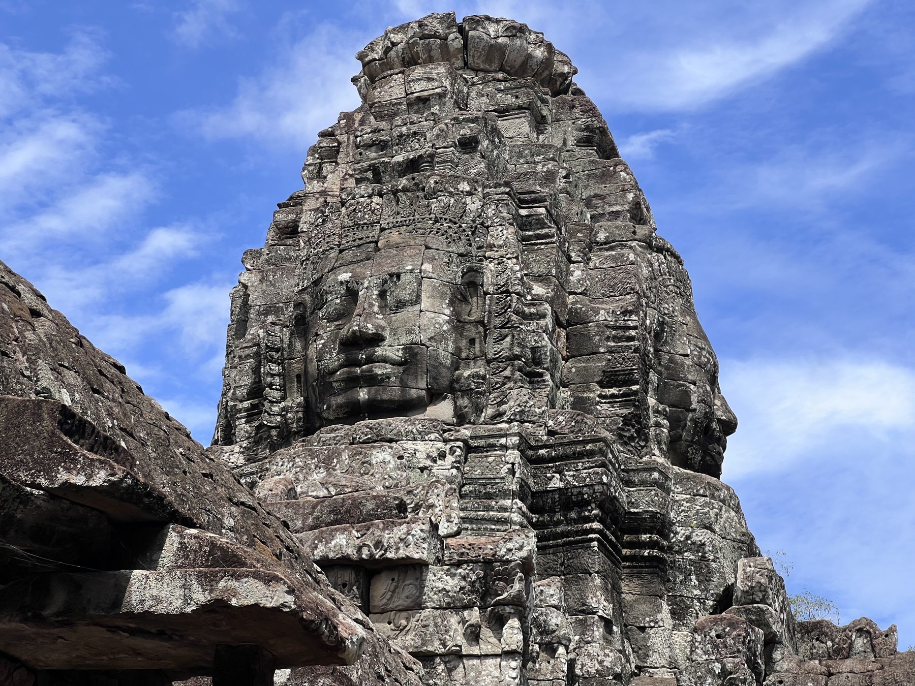 A huge smiling stone face carved into one of the Bayon's towers