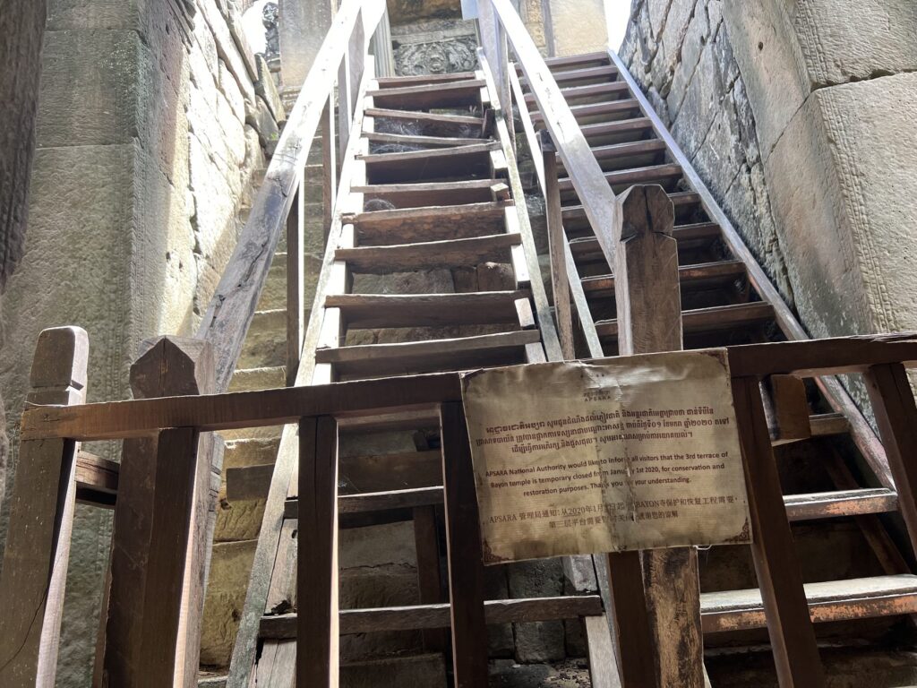 Wooden stairs built over the steep stone steps inside the Bayon