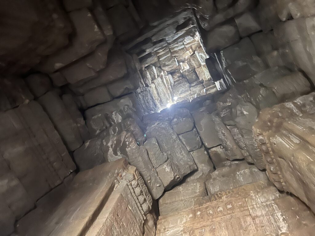 Looking straight up a Bayon tower at the square opening where the capstone used to be