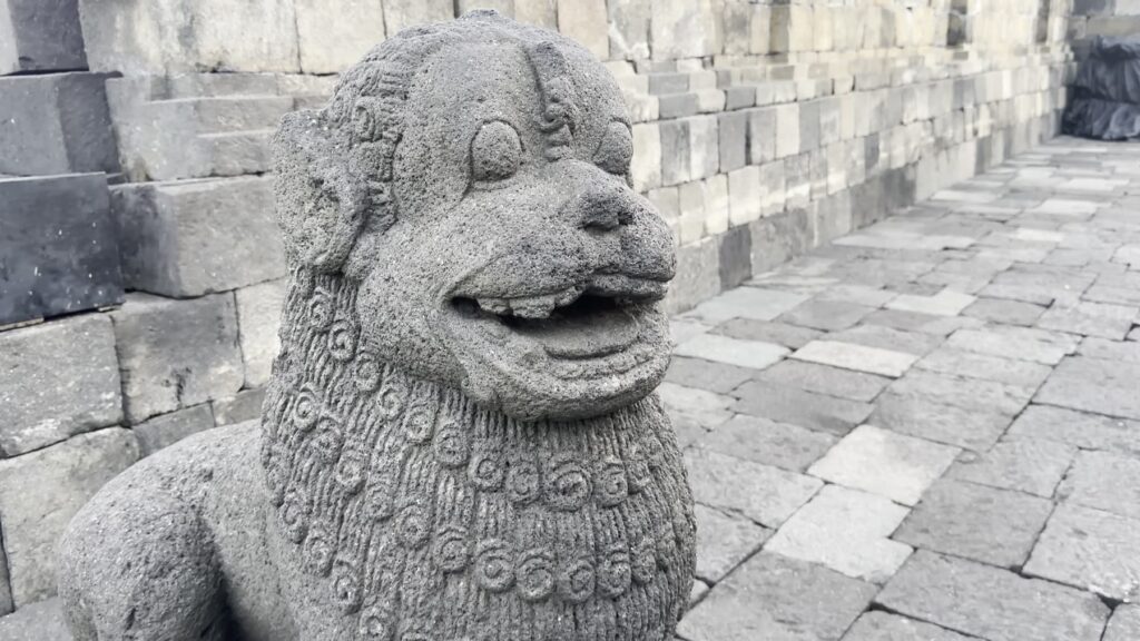 Carved stone lion guardian on a Borobudur terrace