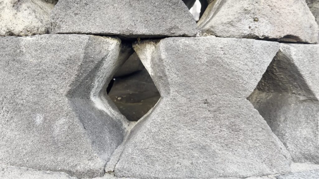 Close-up of the diamond-shaped openings in a Borobudur stupa