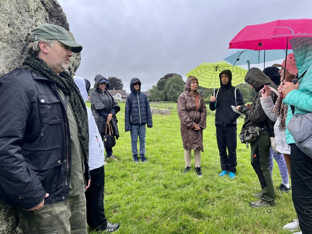 Hugh Newman talking with the tour group in the rain at the Stanton Drew stone circles