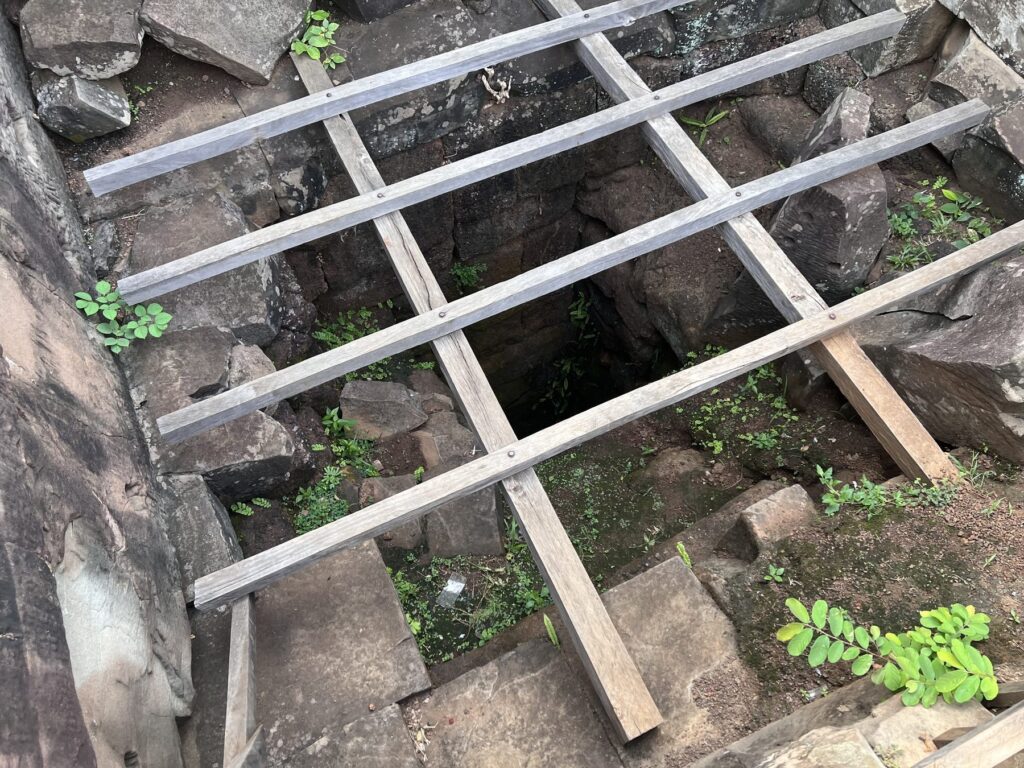 The looters' shaft in the summit of the Koh Ker pyramid, covered with a wooden grid