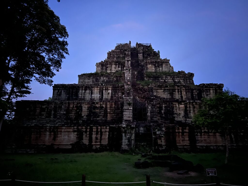 The Prang pyramid at Koh Ker silhouetted against a deep blue sky before dawn
