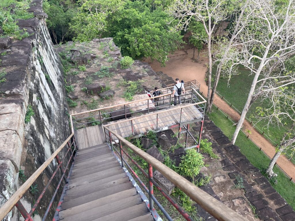 The modern wooden staircase with handrails climbing the Koh Ker pyramid