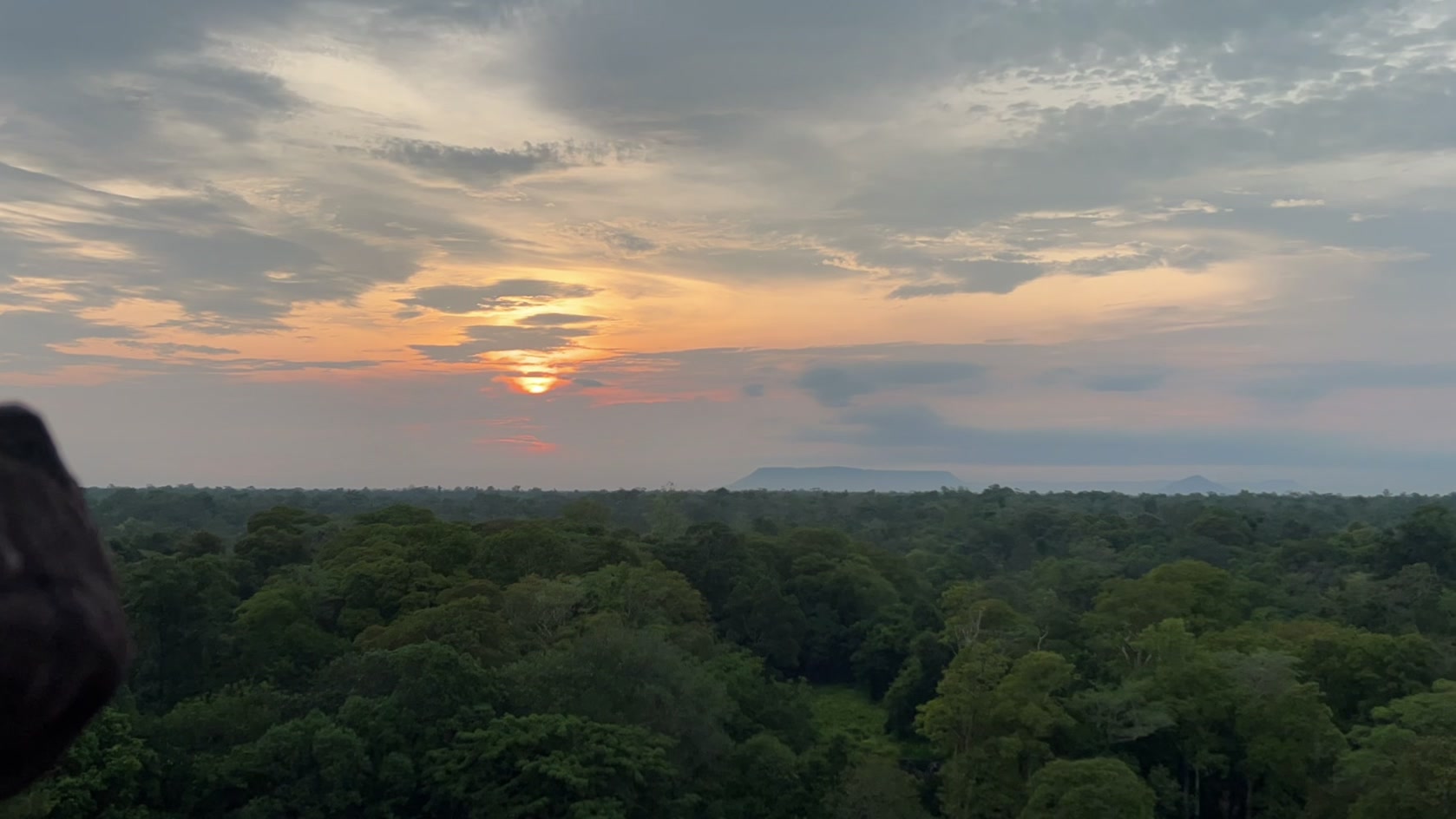The sun coming up on the flat horizon east of Koh Ker on the April zenith sunrise