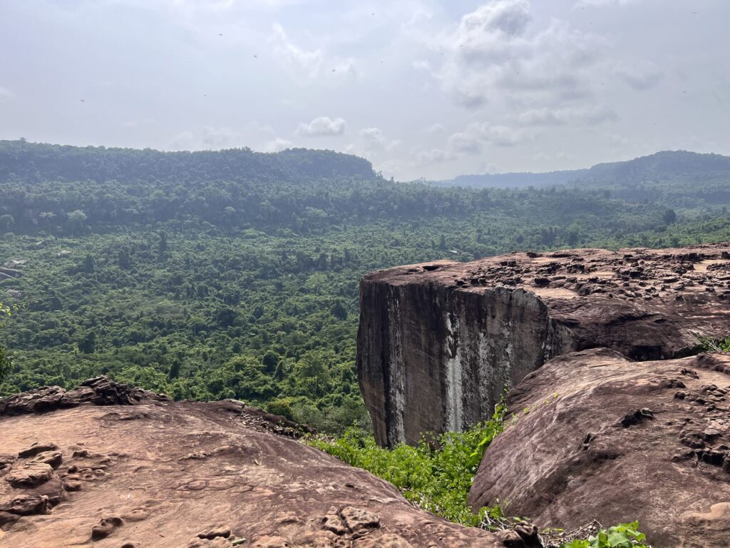 The Amazing Cliff at Poeng Ta Kho on Phnom Kulen, a sandstone ledge above endless green jungle