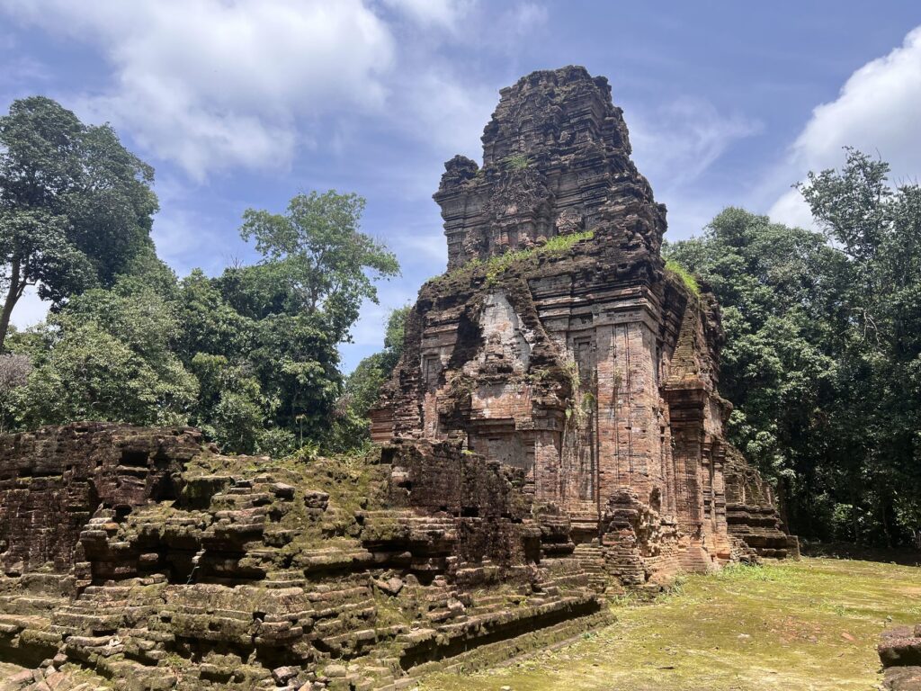 The brick sanctuaries of Damrei Krap temple in a grassy jungle clearing