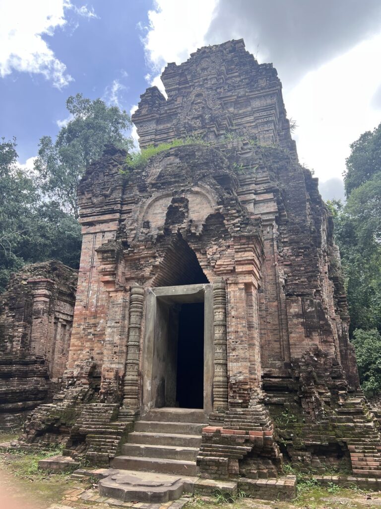 A tall brick tower of Damrei Krap with a carved doorway