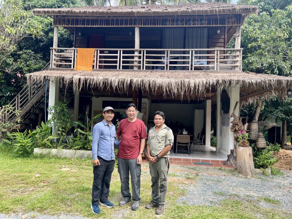 The author with Kanha and the camp leader in front of the base camp house