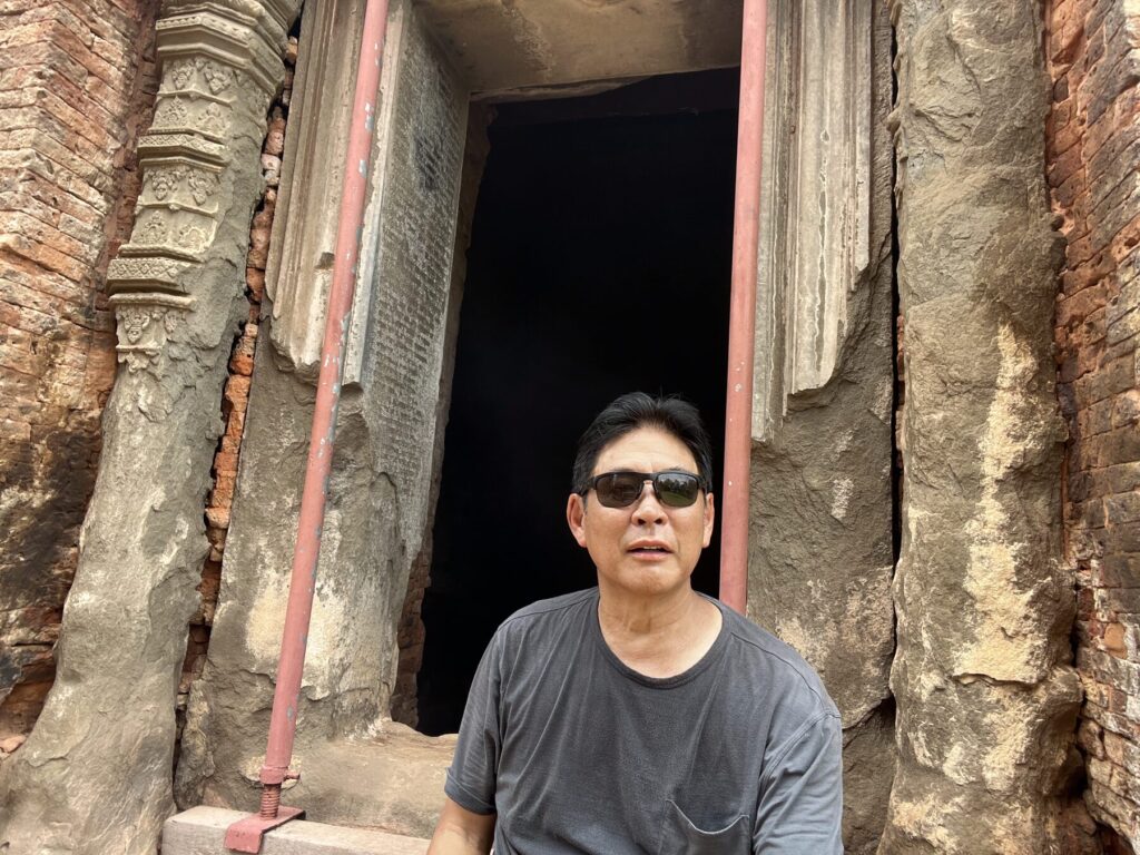 The author sitting in the doorway of the back right tower at Lolei