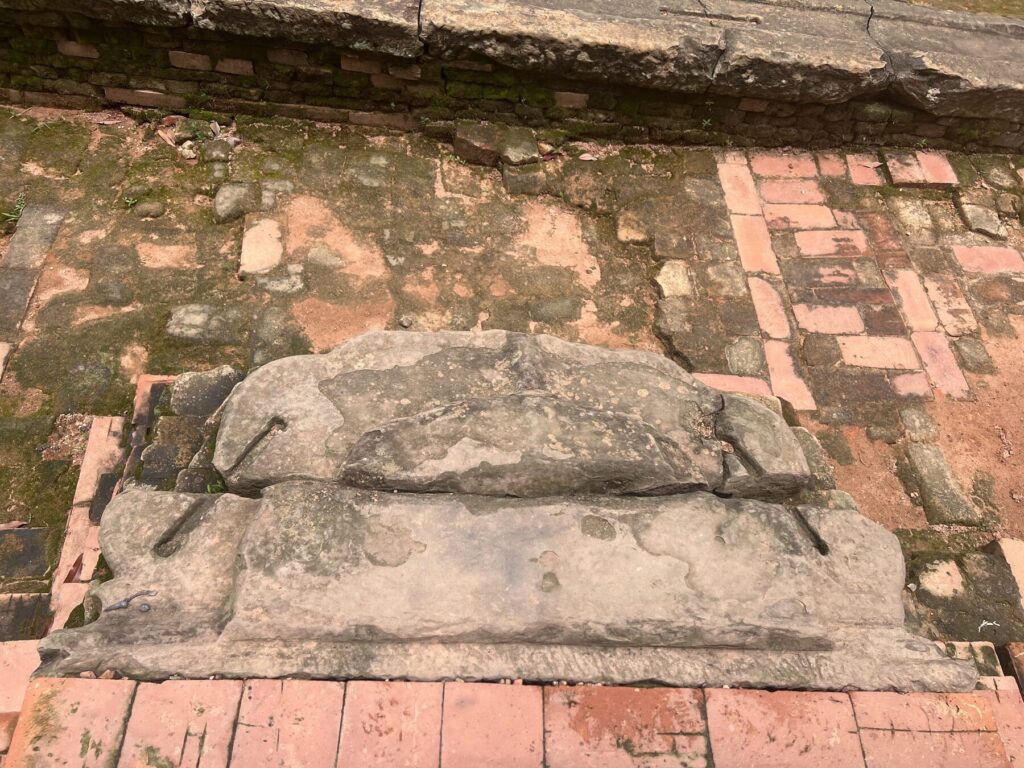 A stone block at Lolei with two grooves cut into it, each with drill holes at the ends