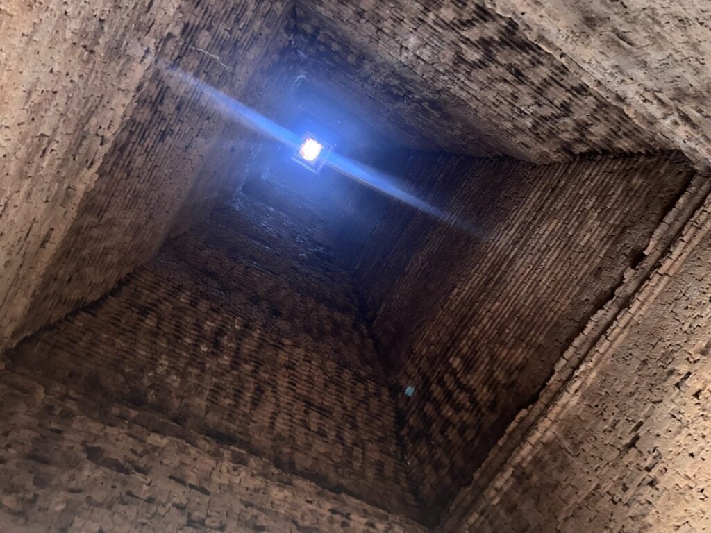 Looking straight up inside a Lolei tower at the small opening at the top