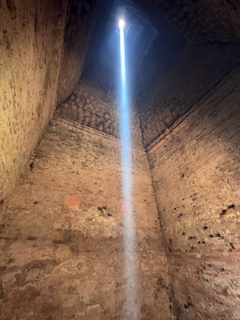 The zenith sunbeam moving off center as it leaves the chamber at Lolei