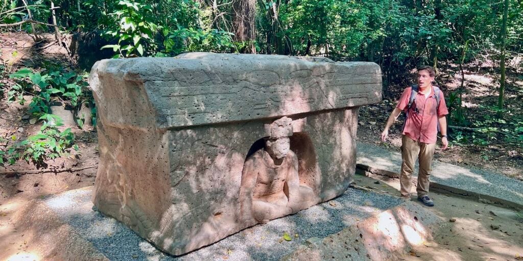 Luke Caverns examining an Olmec carved stone altar