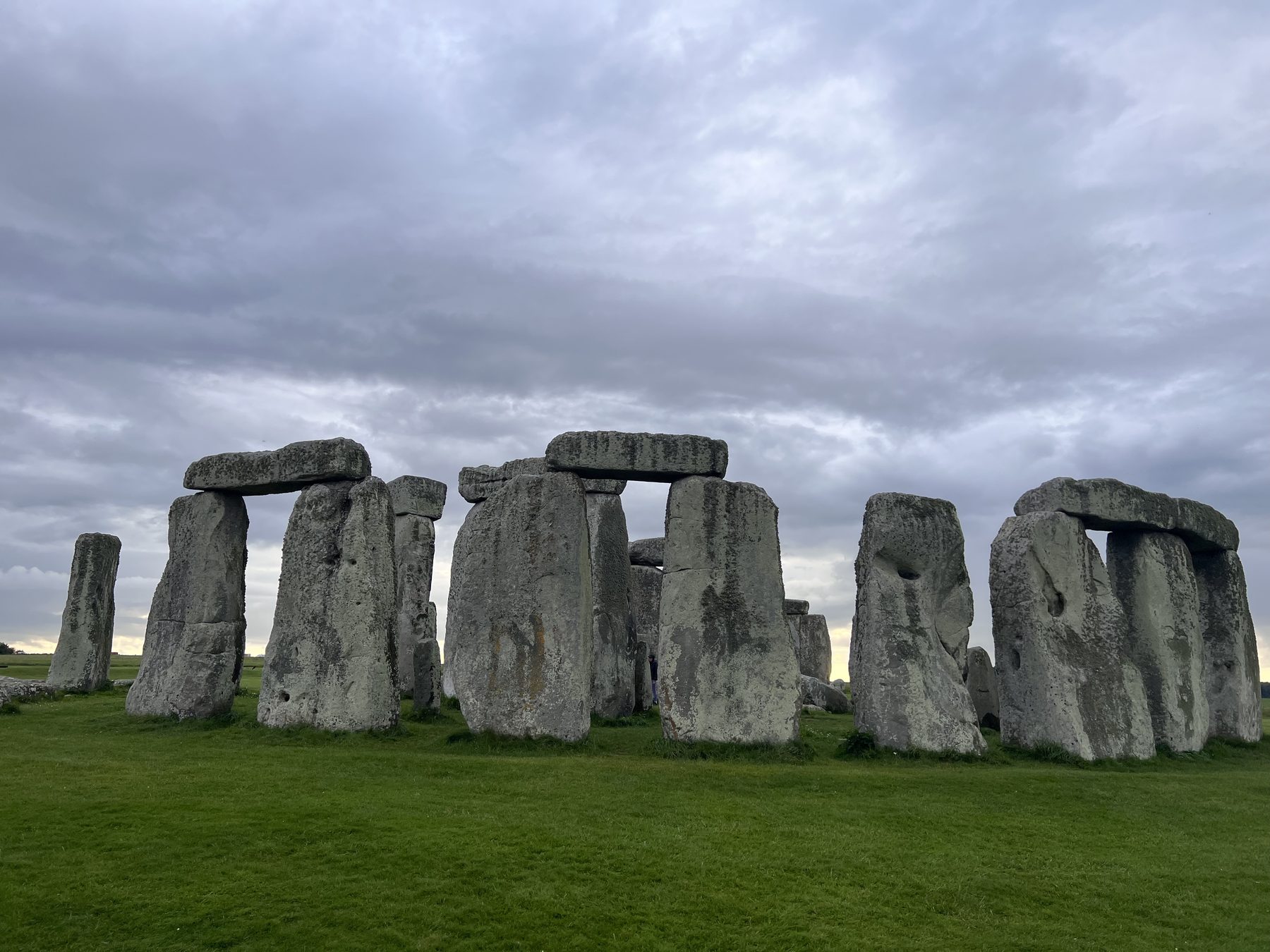 Stonehenge under a heavy grey sky on the Megalithomania Mysteries of Ancient England tour